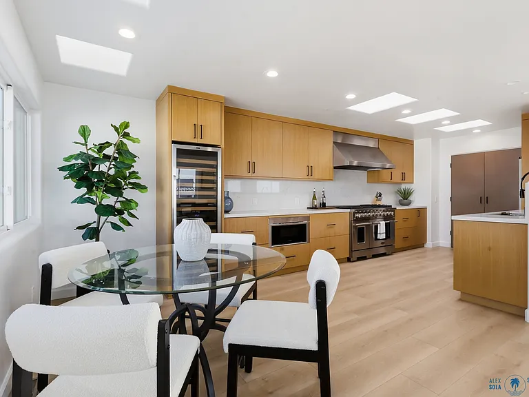 At the top of the third floor you will find a chef's kitchen with walk-in pantry, breakfast nook, 8-sit dining table, and rooftop patio with direct stair access to the street