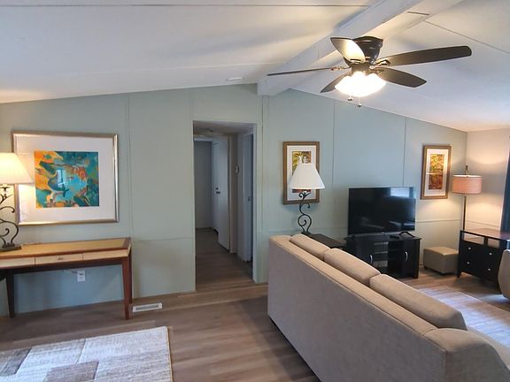 This half of the living room could be used as a toy room, gaming area, etc