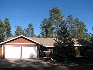 Nestled in the tall pines, with undeveloped land bordering the backyard.