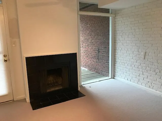 Exposed brick and fireplace (2nd fireplace) in bedroom!