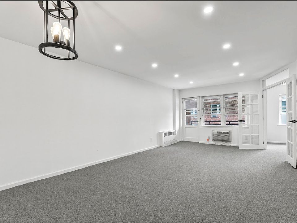 Living room/dining area with doors to second bedroom and door to terrace.