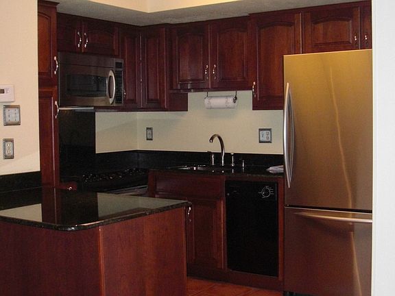 Kitchen with Granite counter tops, stainless appliances and tile floors.