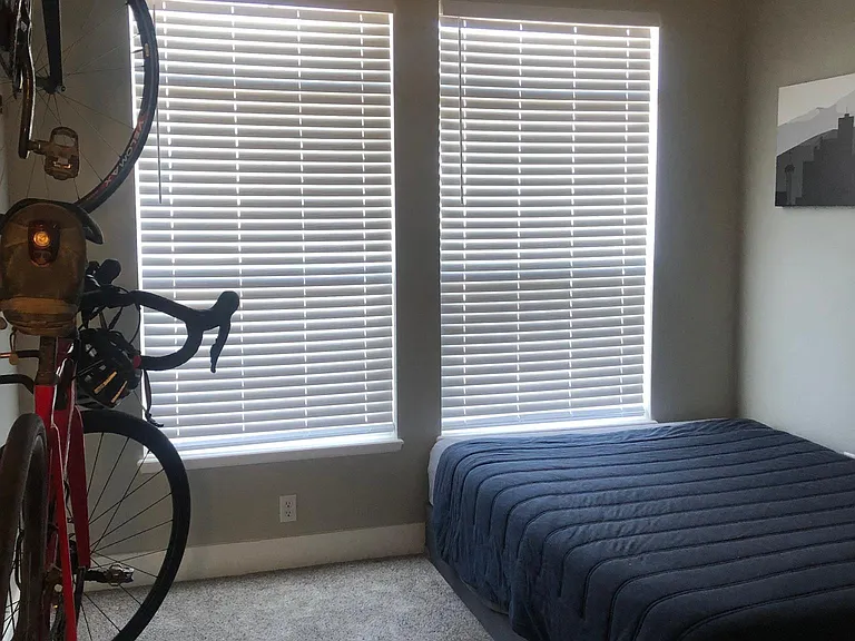 Second bedroom with large West-facing windows. Currently has on-wall bike racks, which can be removed upon request. Building features bike storage in the underground garage as well