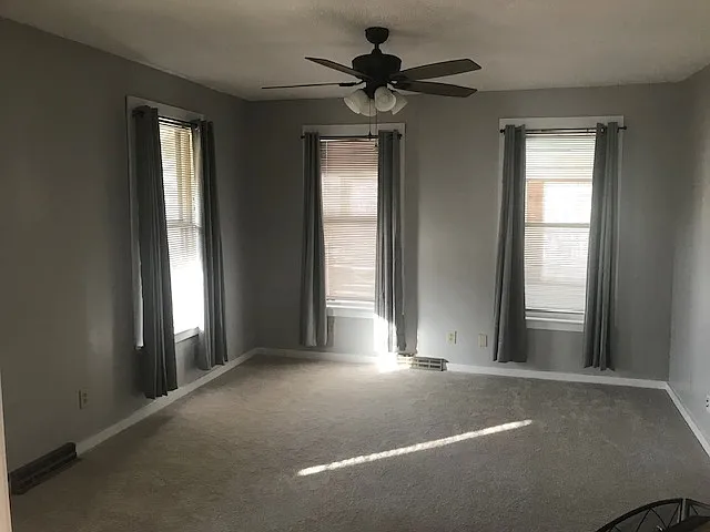Living room with fresh paint and curtains.