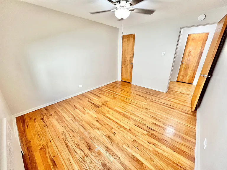 Embrace serenity in this bright bedroom featuring elegant hardwood flooring. Embrace serenity in this bright bedroom featuring elegant hardwood flooring.