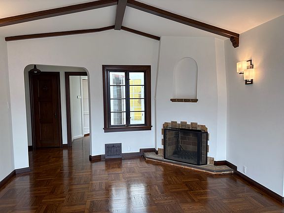 Living room with decor only fireplace and refinished floors