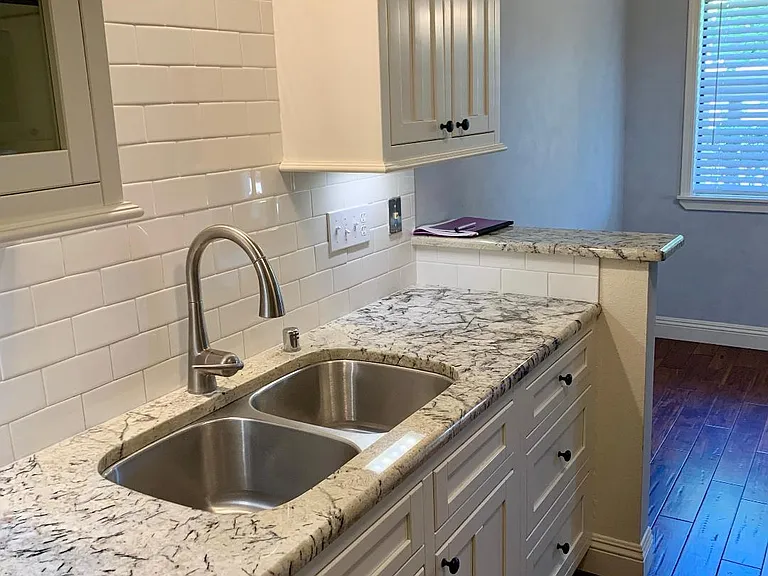 Lady luxe faucet, granite countertops, white Shaker cabinets