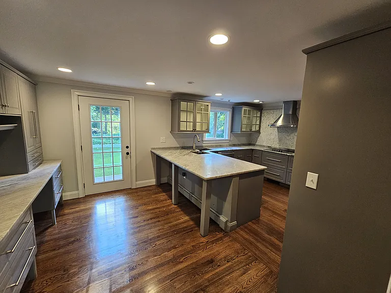Kitchen _ View 1
Main-level kitchen with hardwood floors, a central island, extensive cabinetry, and direct access to the backyard.
