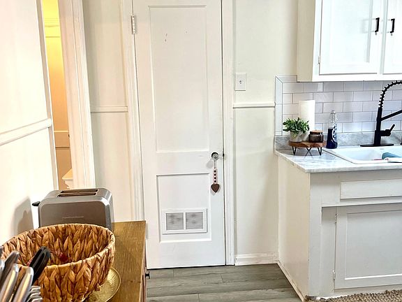kitchen with new flooring, stone countertops and backsplash