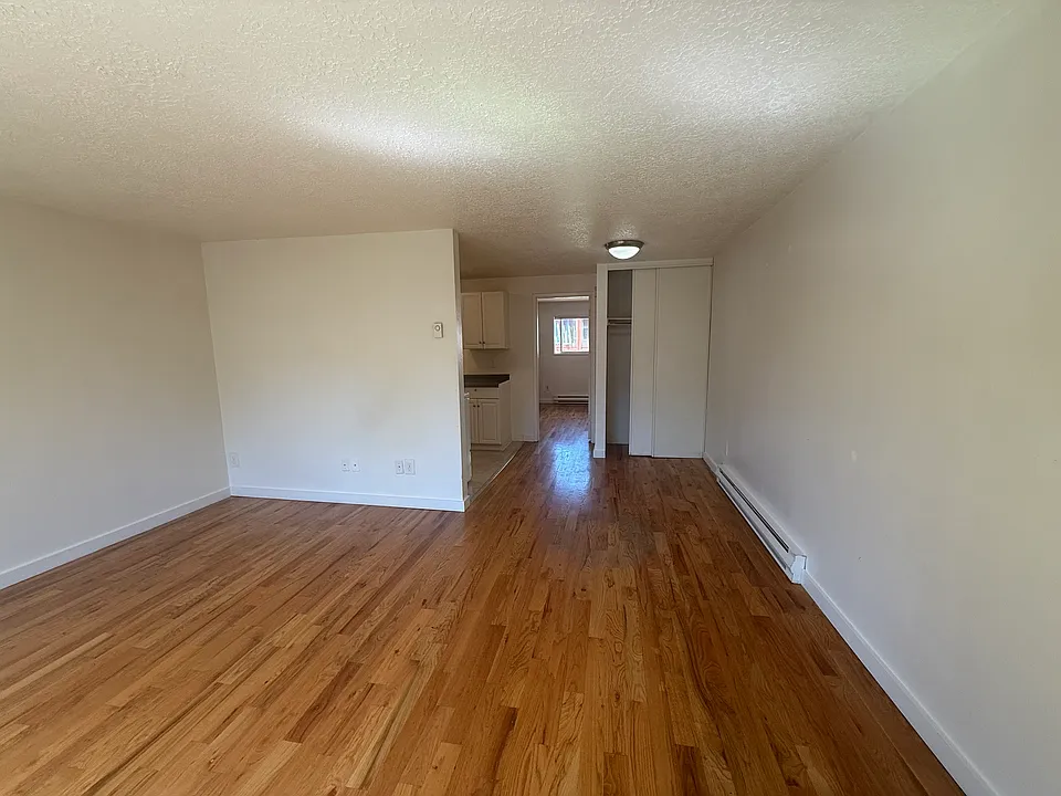 Living room, looking into dining and kitchen.