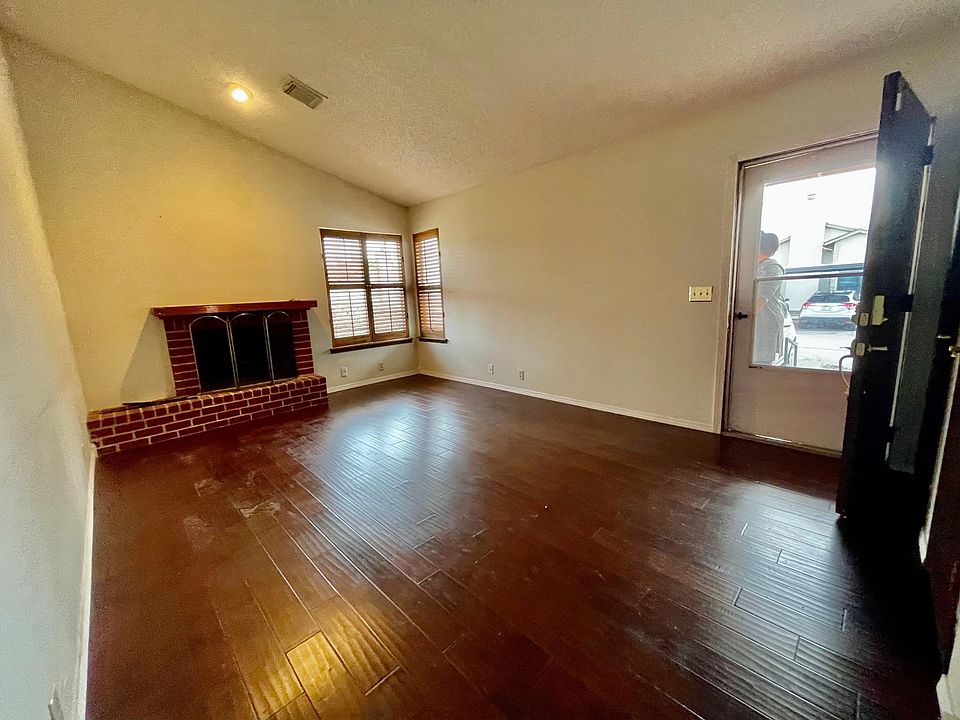 Living Area with Wood window Shudders and wood burning Fireplace.