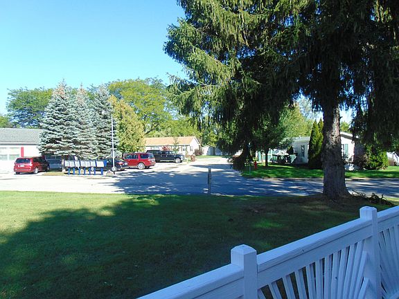 Looking North West from your front Porch. Notice the lovely mature shade tree in the front yard.