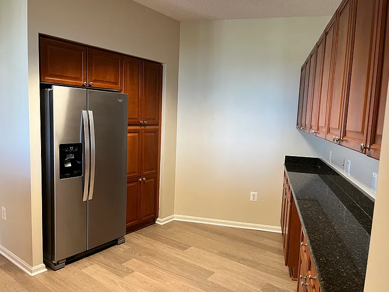 Kitchen with new fridge and more cabinets