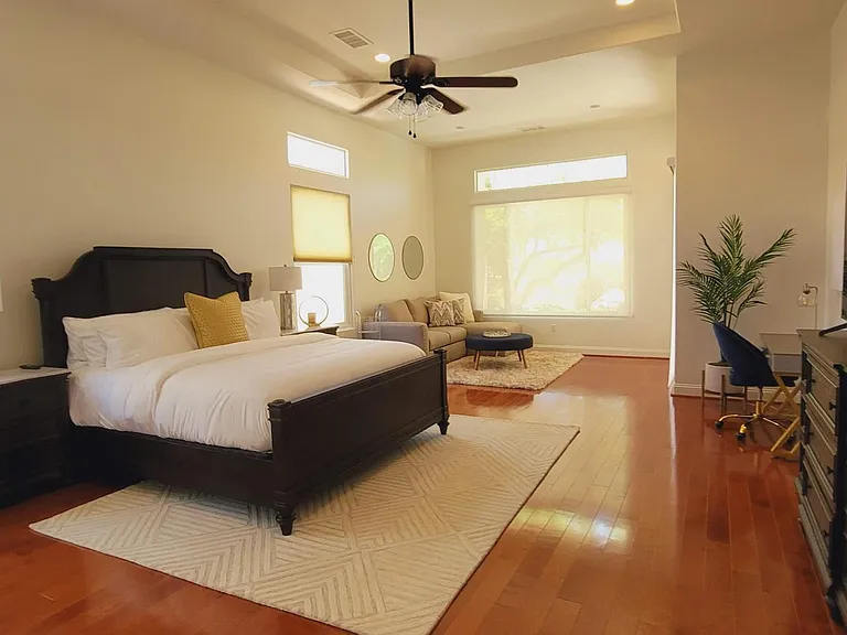 Primary bedroom, very large, includes couch with pull out bed, desk, large TV