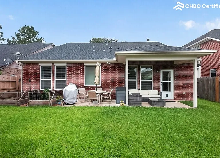 Open backyard with covered back patio