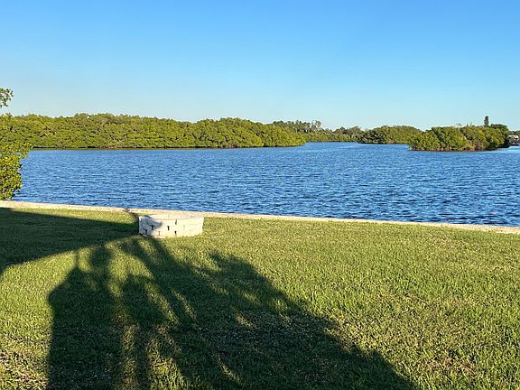 View of the Little Manatee Preserve from the covered lanai shows part of the back yard and fire pit.