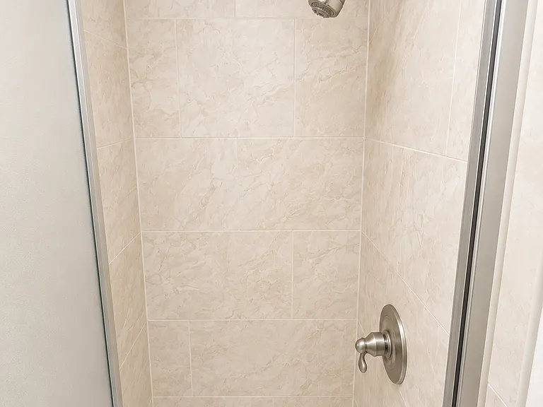 Clean, modern walk-in shower with updated tile surround.