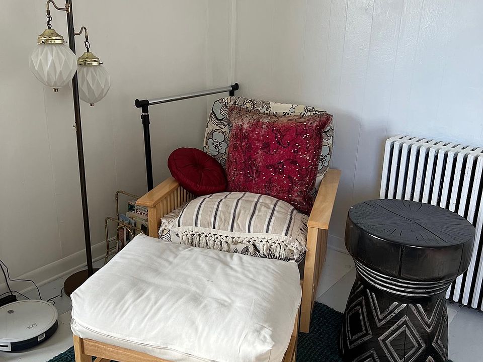 Sitting area with futon chair and vintage light