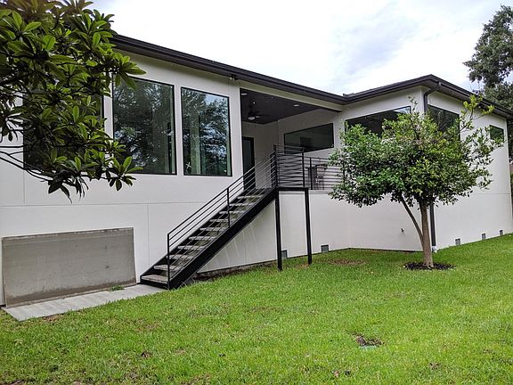 Covered Patio with outdoor sink overlooking back yard. Bamboos line back fence to offer green view and privacy.