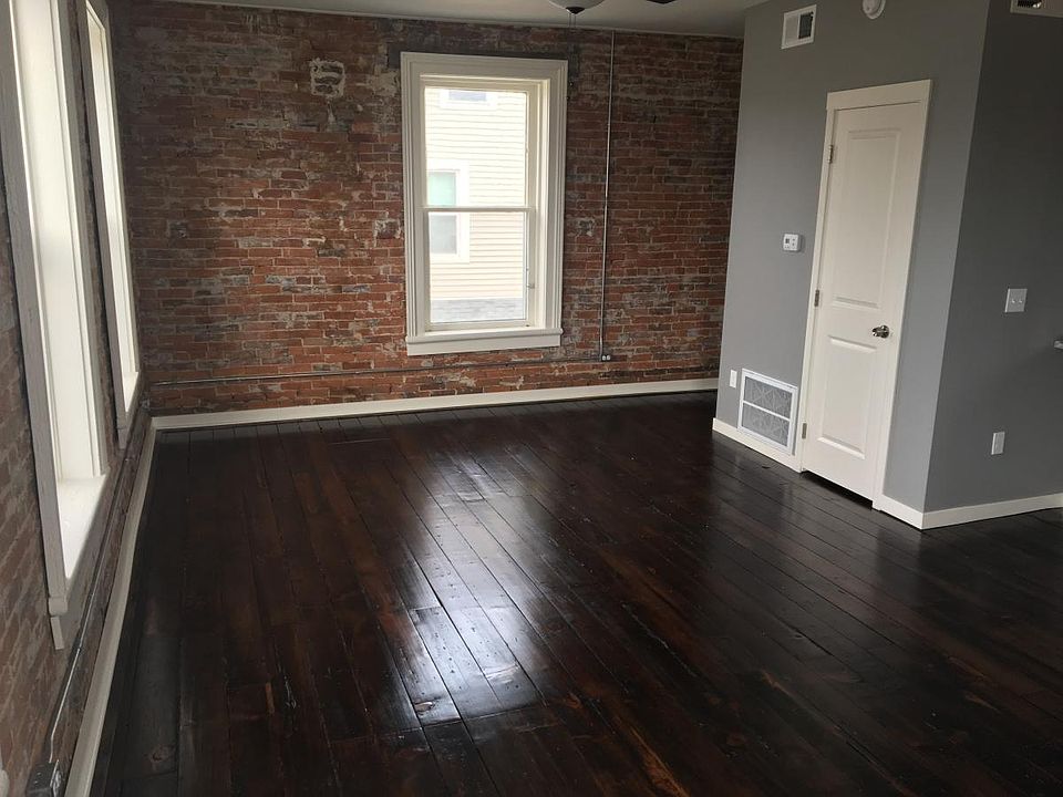 Amazing natural light with open concept living room with storage closet.