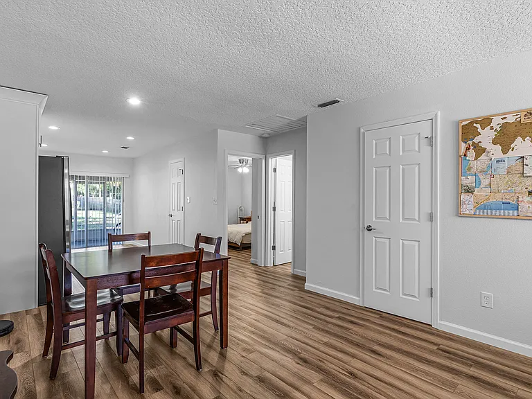 Open concept kitchen, dining, and living rooms.