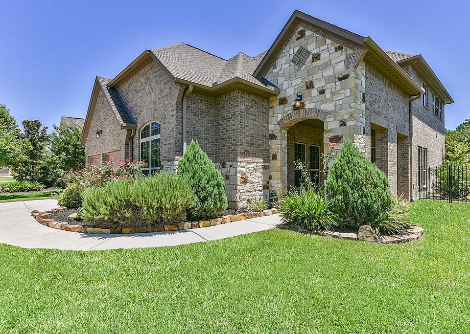 This large inviting front porch with covered brick and stone is open on side to let the breeze come through! Plenty of room for big patio furniture!