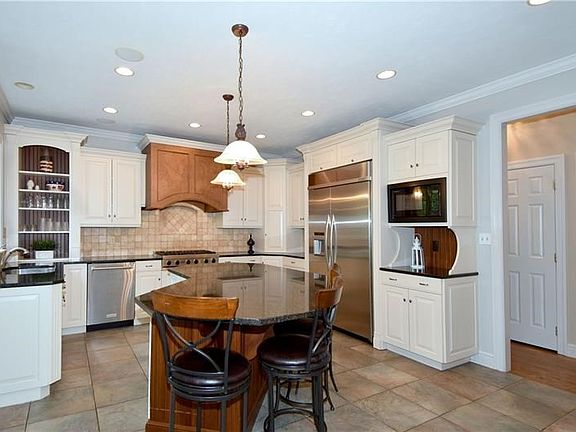 Well designed center Island kitchen with its Rutt cabinetry and professional grade appliances will impress any chef.