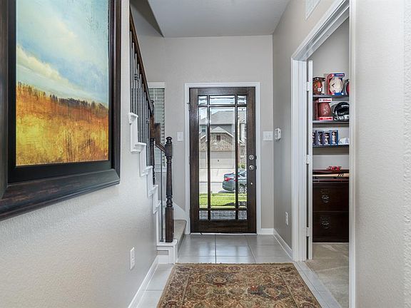 Classic details include the fabulous glass door, and the wood and wrought iron staircase that leads to the upstairs living space