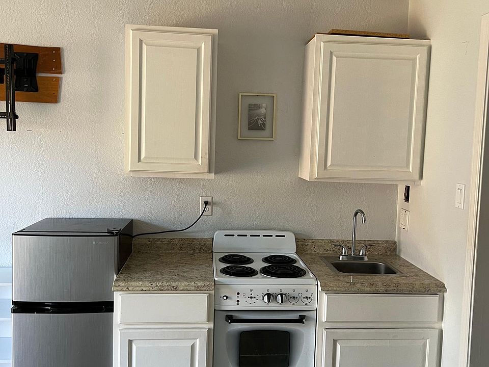 fridge is included , a kitchen with storage , sink , stove