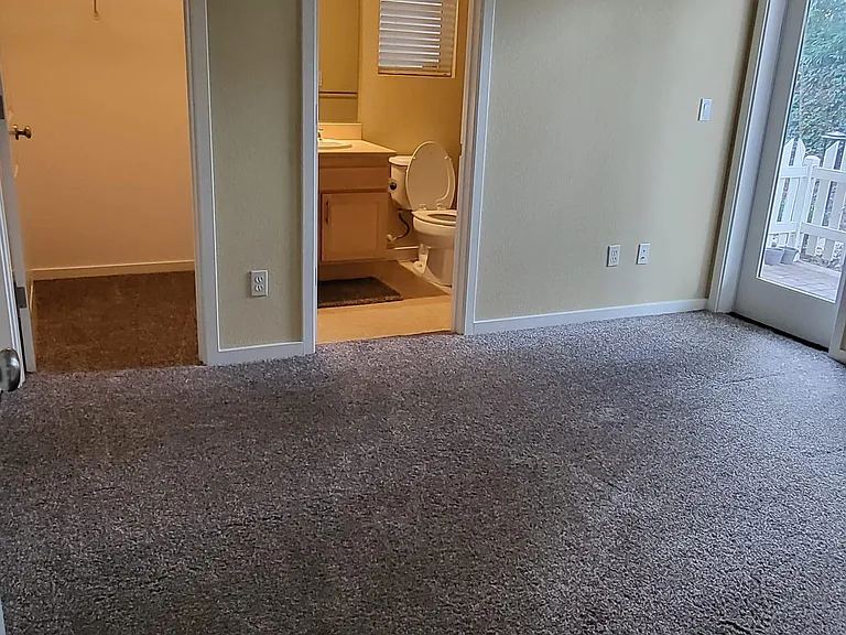 Bedroom 3 on the ground floor with attached bathroom and closet with access to patio