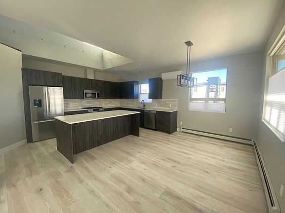 Large open-concept kitchen and dining room. New Bosch appliances and hardwood floors throughout downstairs.
