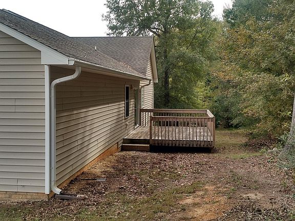 Back of home showing deck. Notice the nice trees!