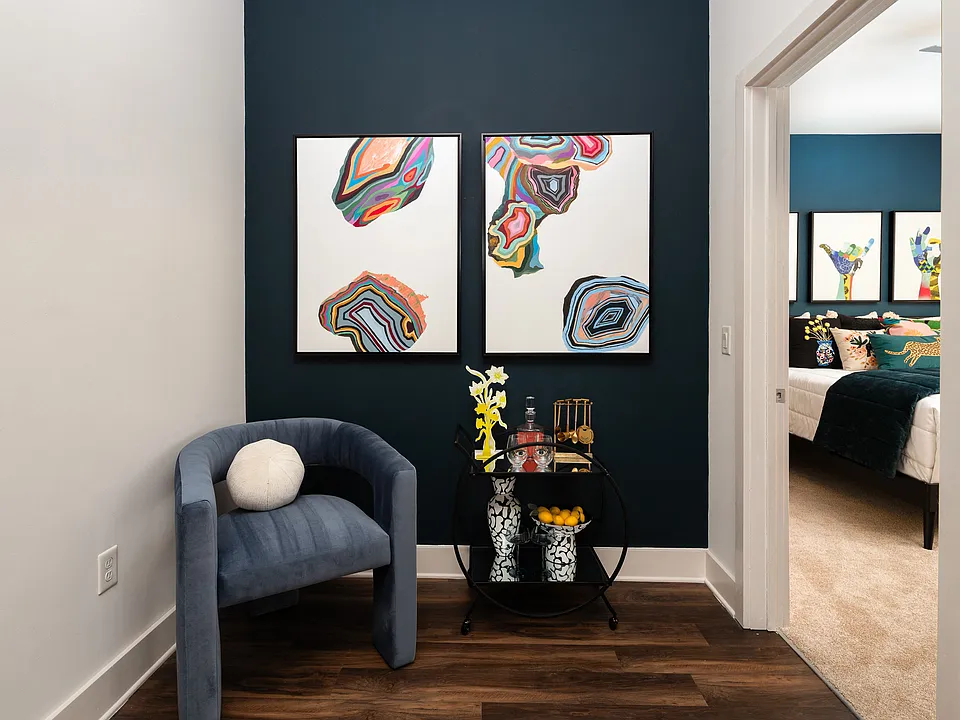 A pocket of space near the bedroom door, big enough for a chair and a cart.