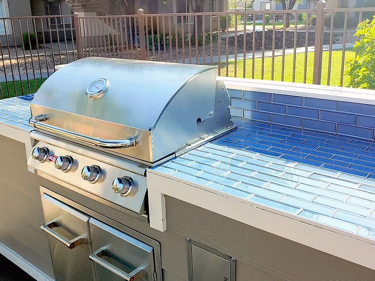 Our poolside outdoor grilling station boasts a ready-to-go, stainless steel gas grill and ample countertop space for the ultimate BBQ cookout extravaganza.