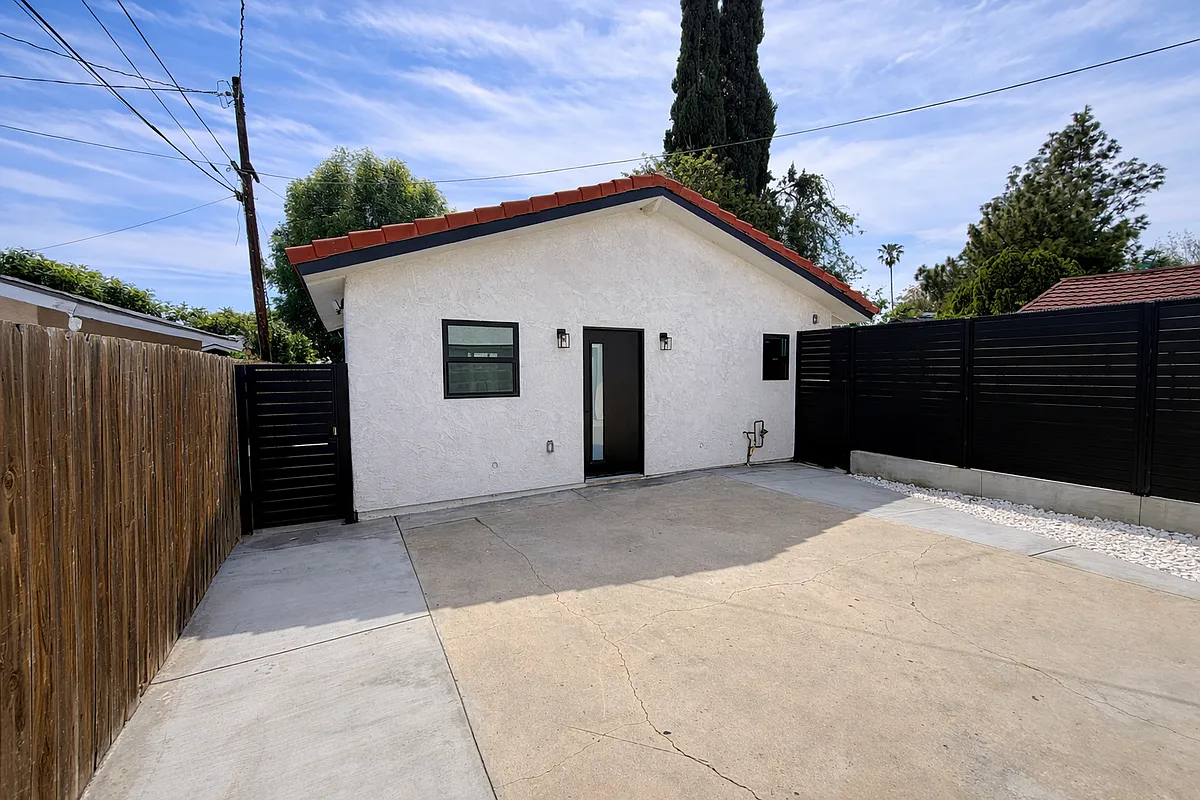 Alternate view of the ADU's private outdoor area with stylish black fencing and a clean, low-maintenance setting. - 19146 Chase St