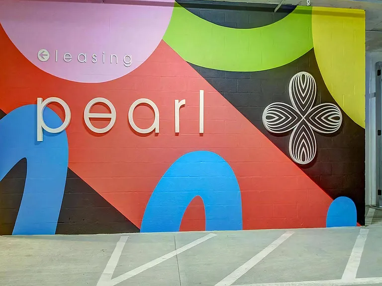 Colorful Wall Mural With "Pearl" and Directional Sign for Leasing Office