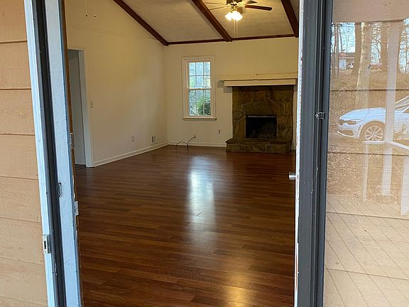 from front door walking into vaulted great room with fireplace. Hardwood floors