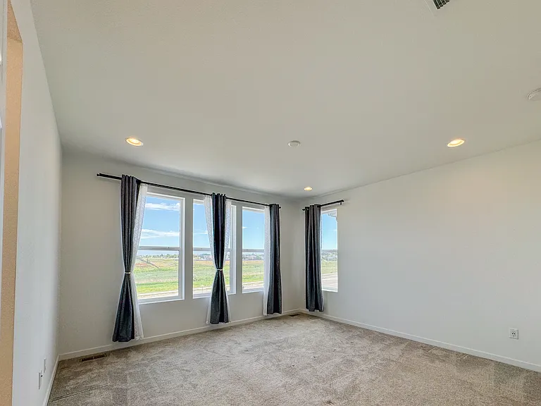 Warm, comfortable master bedroom with plenty of natural light