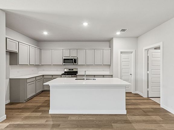 Kitchen in the Oscar home plan by Trophy Signature Homes - REPRESENTATIVE PHOTO