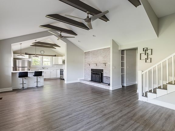 Vaulted ceilings and an open concept living room. Wood burning fireplace. Bar stools included.