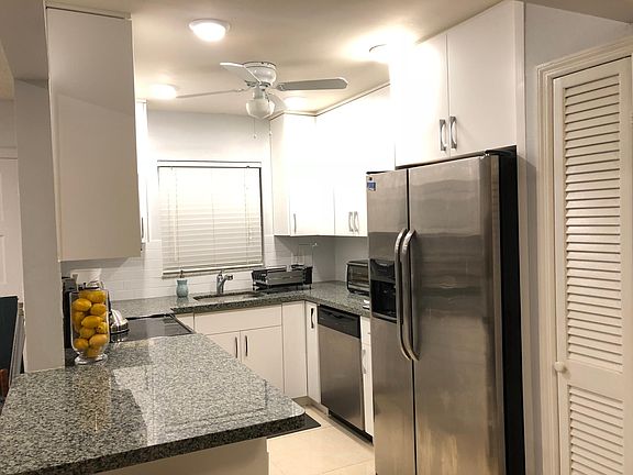 Renovated Kitchen with Granite Counters, lots of storage, soft close drawers, tall cabinets up to the ceiling.