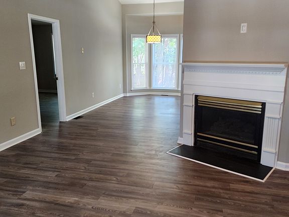 View from front door. Open floor plan. High ceilings. Neutral paint & LVP flooring throughout.
