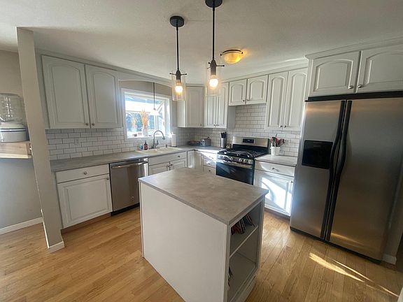 Kitchen has a garden window box over the kitchen sink as well as as island.