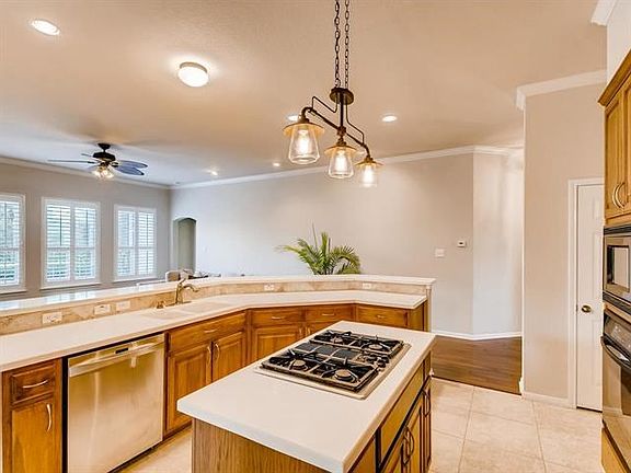 Awww! A clean pristine kitchen.  Does Mr/Ms Sparkle live here?  Kitchen island. Stainless steel appliances. Upgraded light fixture. Hard tile floor.  Light and bright!