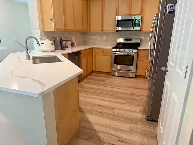 Upgraded kitchen: Brand new quartz countertop and tile backsplash, waterproof flooring