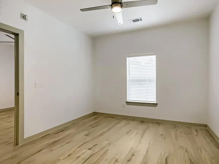 bedroom with window and ceiling fan