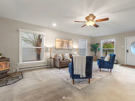Large living room with tons of seating options. Disclosure: Pellet stove is not operational. 