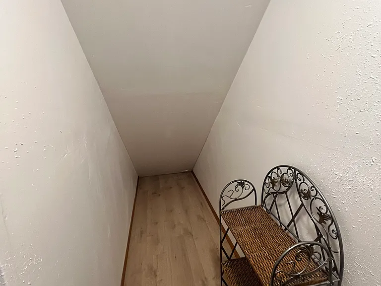 Under stairs flex space for storage or shelving.
