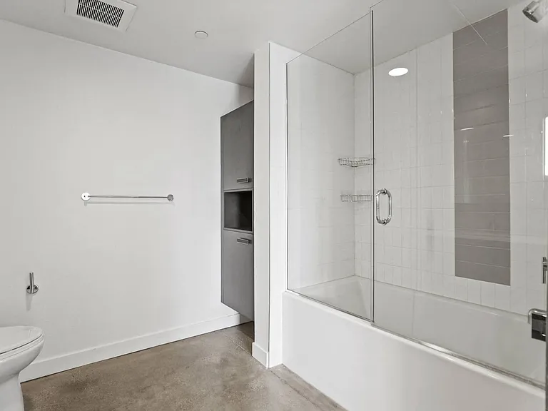 Bathroom with Shower Bath with Glass Door and Built-In Cabinet Storage