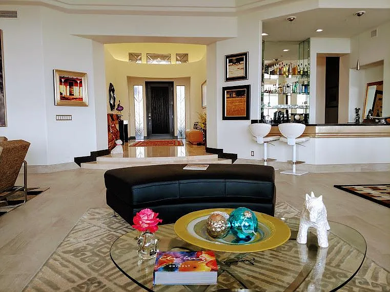 Art deco inspired touches create the ambiance of a resort just inside your front door.